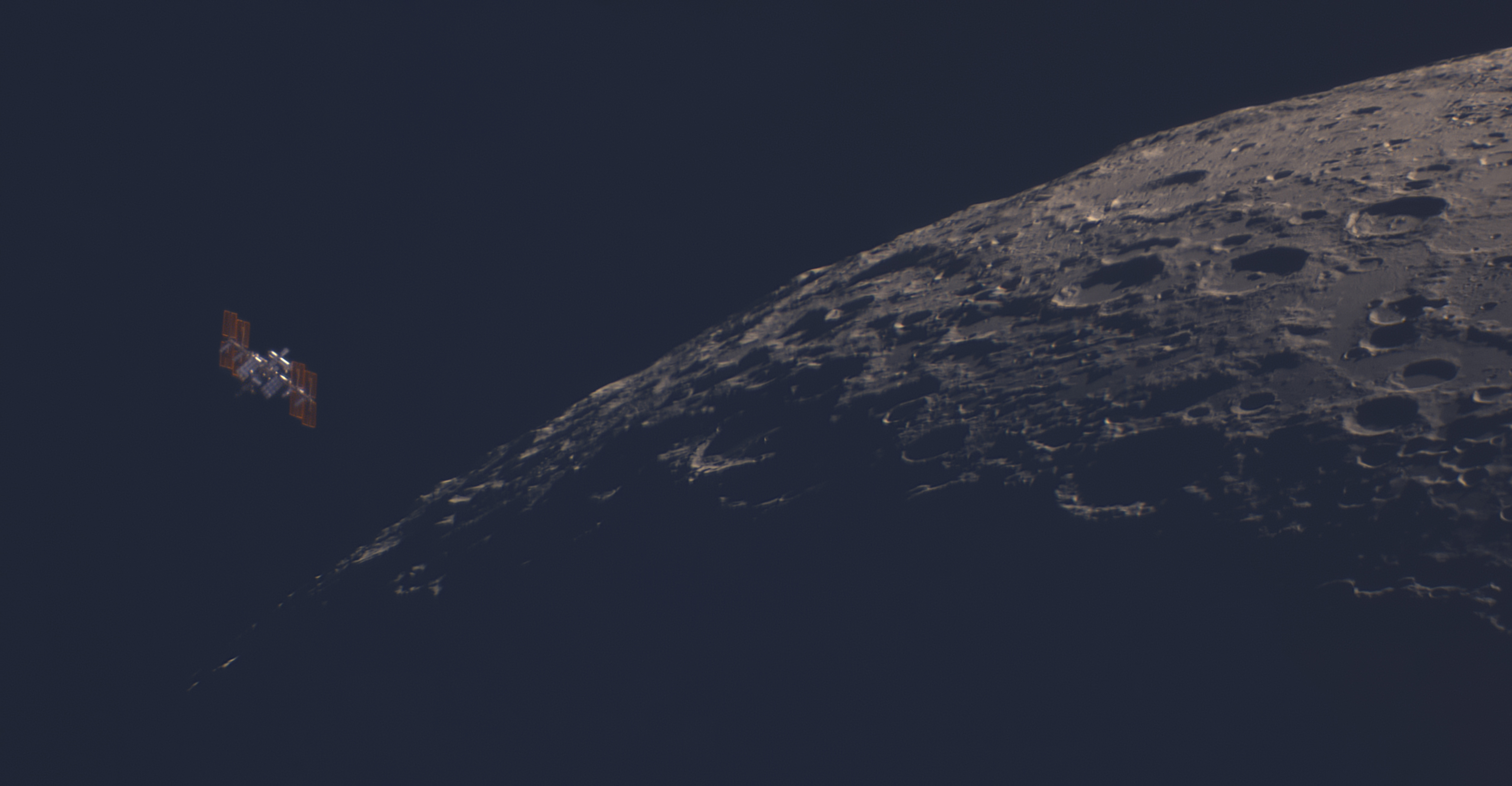 This image shows the International Space Station making a close pass of our Moon. 